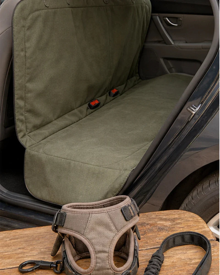 Backseat cover installed with accessible seat buckles and a separate pet restraint shown beside it