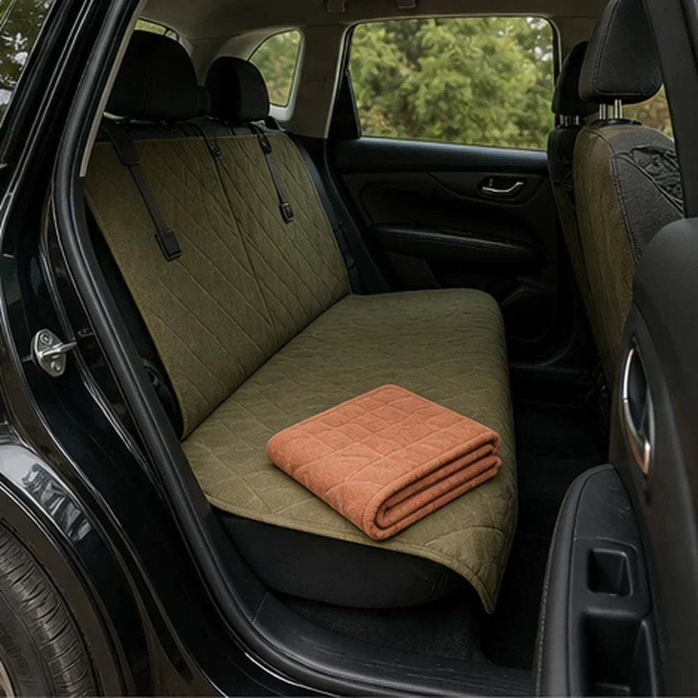 A folded travel mat and installed backseat cover beside an open car door
