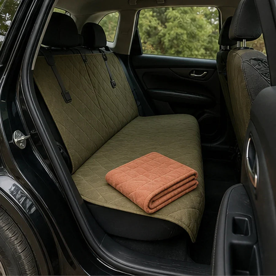 A folded travel mat and installed backseat cover beside an open car door